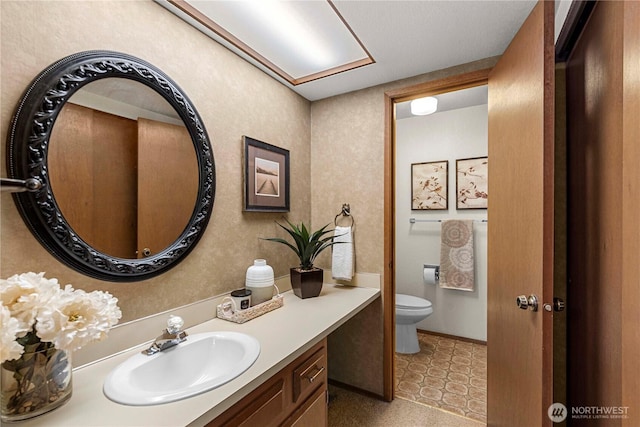 half bathroom with vanity, toilet, and tile patterned floors