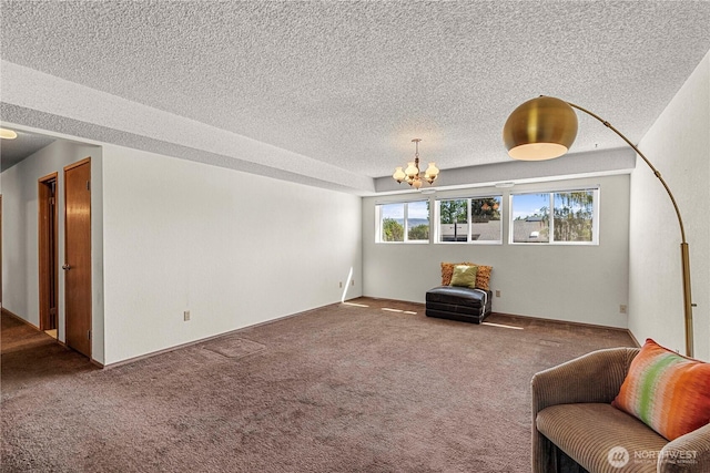 sitting room featuring a chandelier, a textured ceiling, and carpet floors