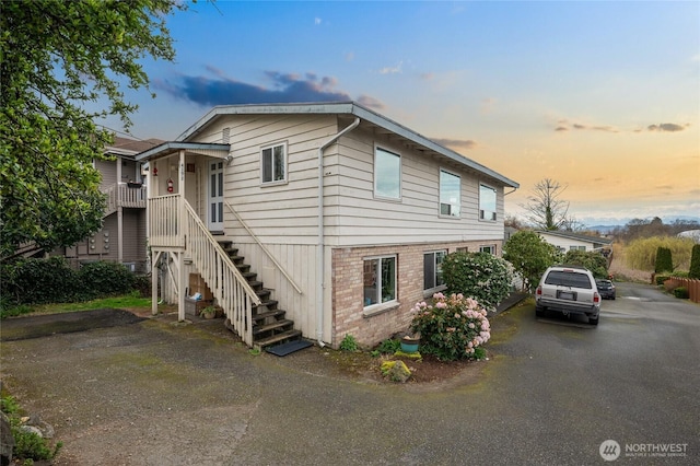 view of side of home with stairway