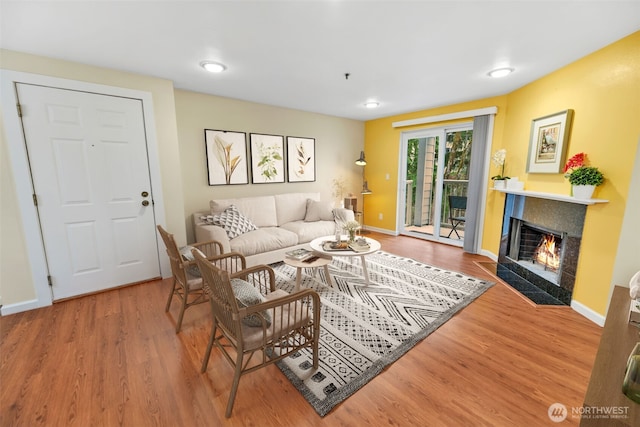 975 Aberdeen Ave NE Unit F207, Renton, WA 98056 - living room with a fireplace with flush hearth, wood finished floors, and baseboards