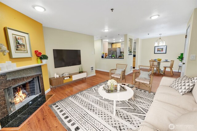 975 Aberdeen Ave NE Unit F207, Renton, WA 98056 - living room with visible vents, baseboards, recessed lighting, wood finished floors, and a premium fireplace