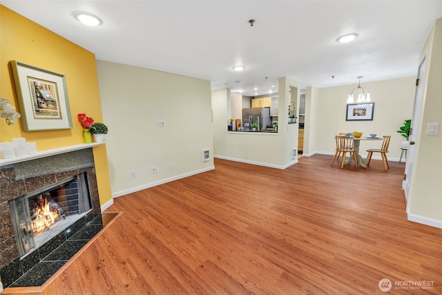 975 Aberdeen Ave NE Unit F207, Renton, WA 98056 - living area featuring visible vents, baseboards, wood finished floors, and a fireplace