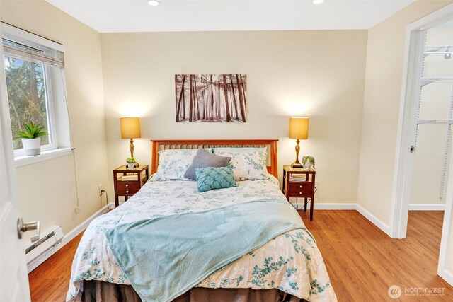 975 Aberdeen Ave NE Unit F207, Renton, WA 98056 - bedroom featuring recessed lighting, a baseboard radiator, baseboards, and wood finished floors