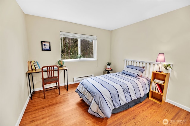 975 Aberdeen Ave NE Unit F207, Renton, WA 98056 - bedroom featuring light wood-type flooring, a baseboard heating unit, and baseboards