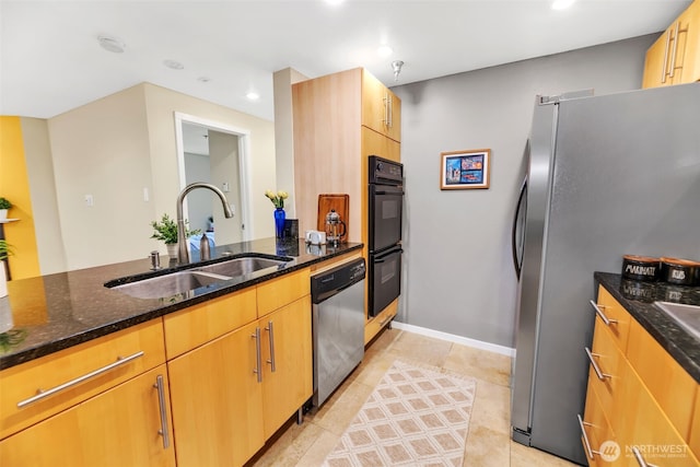 975 Aberdeen Ave NE Unit F207, Renton, WA 98056 - kitchen featuring a sink, light tile patterned floors, dark stone counters, and stainless steel appliances