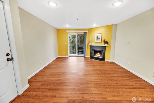 975 Aberdeen Ave NE Unit F207, Renton, WA 98056 - unfurnished living room featuring recessed lighting, a fireplace with flush hearth, light wood-style floors, and baseboards
