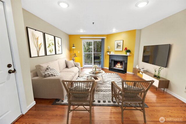 975 Aberdeen Ave NE Unit F207, Renton, WA 98056 - living area with wood finished floors, baseboards, a warm lit fireplace, and recessed lighting