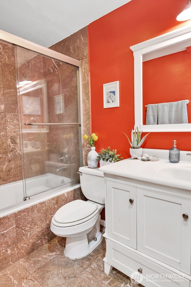 975 Aberdeen Ave NE Unit F207, Renton, WA 98056 - full bathroom with toilet, marble finish floor, vanity, and tiled shower / bath