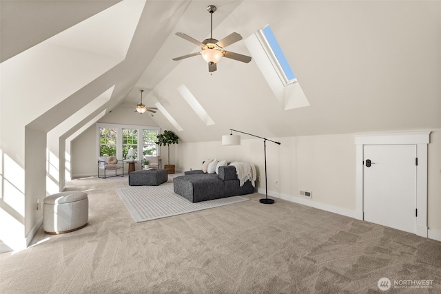 carpeted bedroom with visible vents, lofted ceiling with skylight, and ceiling fan