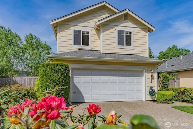 view of front of home with fence, a garage, a shingled roof, and driveway