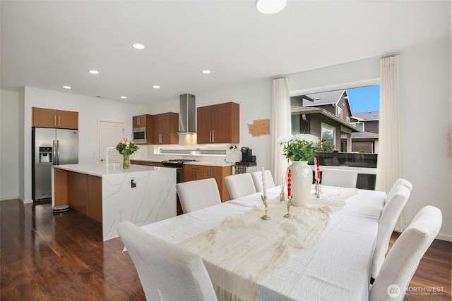 dining room featuring dark wood-type flooring, baseboards, and recessed lighting