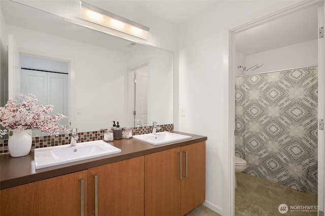 bathroom featuring a sink, double vanity, a shower with curtain, and decorative backsplash