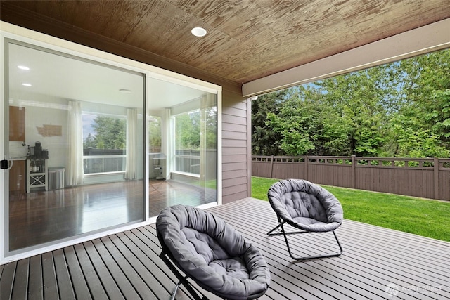 wooden terrace featuring fence and a lawn