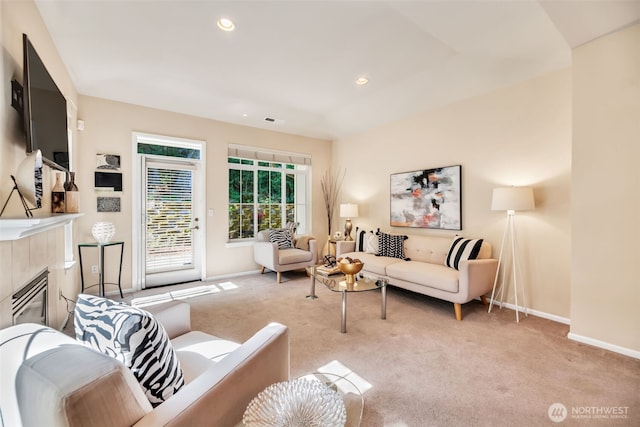 carpeted living room with recessed lighting, baseboards, visible vents, and a tile fireplace
