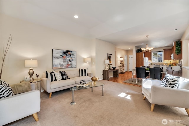 living room featuring recessed lighting, a chandelier, and light carpet