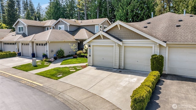 townhome / multi-family property with a shingled roof and driveway