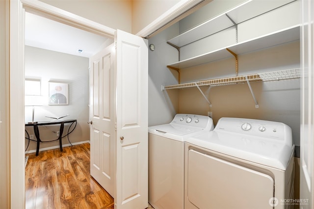 laundry room with laundry area, light wood-style flooring, and washing machine and clothes dryer