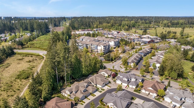 birds eye view of property with a wooded view and a residential view