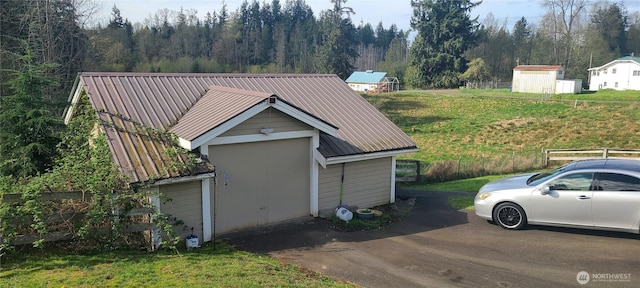 garage with a view of trees