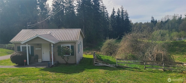 exterior space with a view of trees and fence