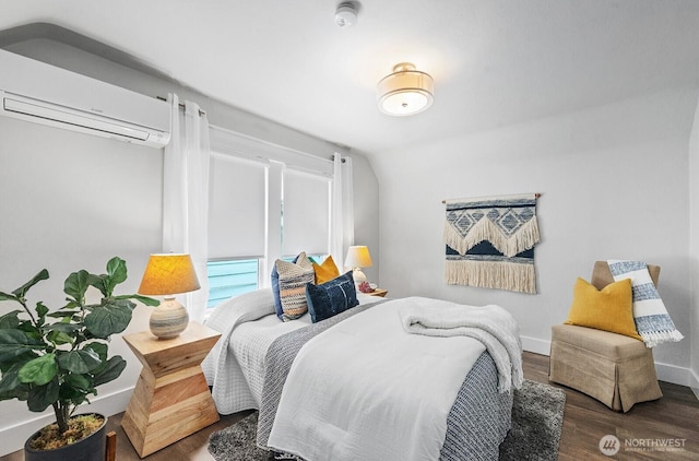 3236 15th Ave S, Seattle, WA 98144 - bedroom with a wall mounted AC, wood finished floors, and baseboards