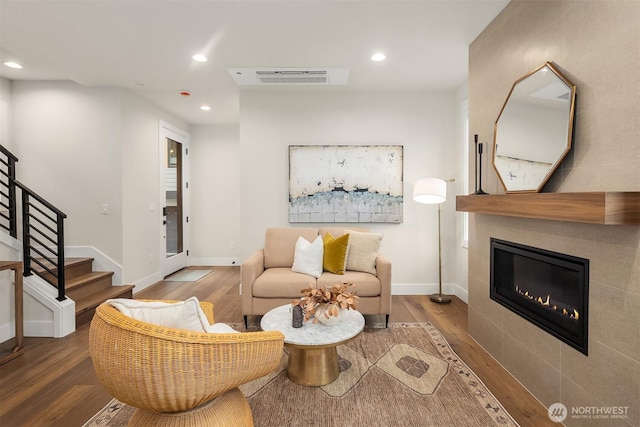 living room featuring visible vents, recessed lighting, stairway, wood finished floors, and baseboards