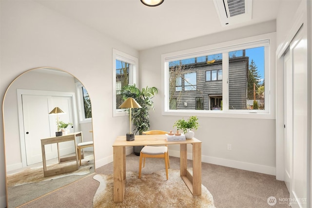 home office with arched walkways, carpet flooring, baseboards, and visible vents