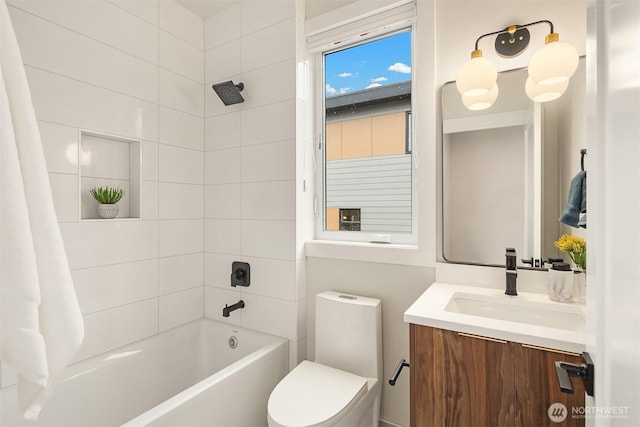 bathroom featuring toilet, vanity, and tub / shower combination