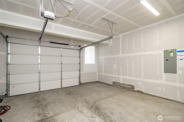 garage with a garage door opener and electric panel