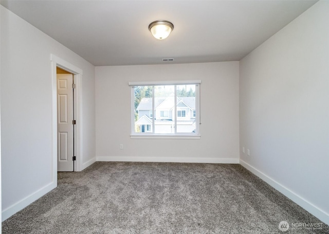 spare room with visible vents, carpet flooring, and baseboards