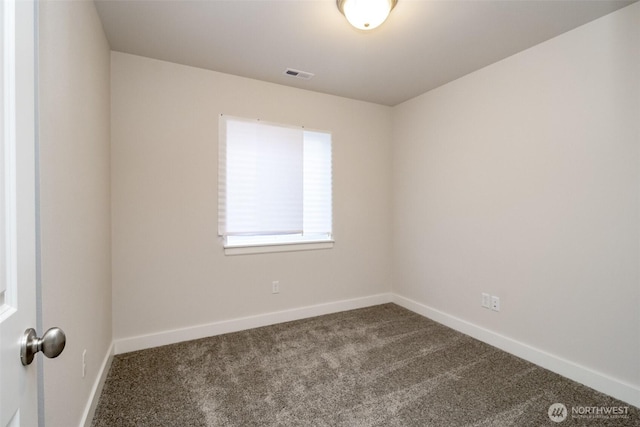 unfurnished room with baseboards, visible vents, and carpet