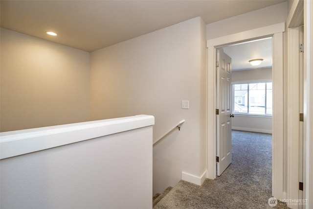 corridor featuring recessed lighting, an upstairs landing, carpet floors, and baseboards
