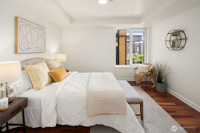 10047 Main St Unit 413, Bellevue, WA 98004 - bedroom featuring wood finished floors, baseboards, and a tray ceiling