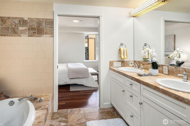 10047 Main St Unit 413, Bellevue, WA 98004 - full bathroom featuring ensuite bath, double vanity, and a relaxing tiled tub