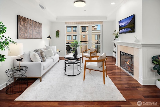 10047 Main St Unit 413, Bellevue, WA 98004 - living area with a tiled fireplace, baseboards, dark wood-style floors, and recessed lighting