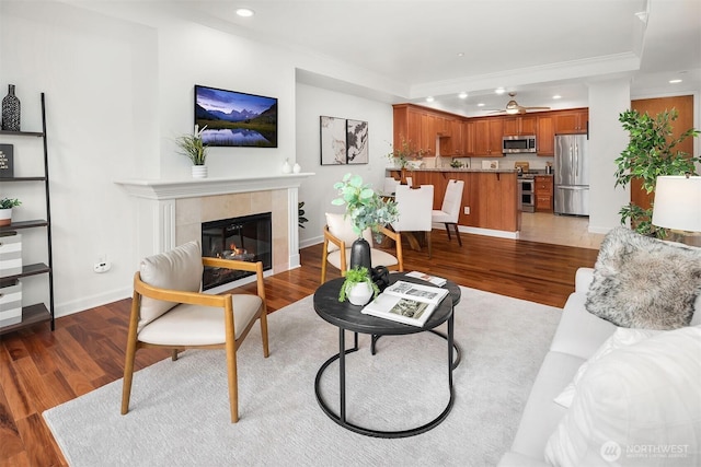 10047 Main St Unit 413, Bellevue, WA 98004 - living area featuring recessed lighting, light wood-style floors, a tiled fireplace, baseboards, and ceiling fan