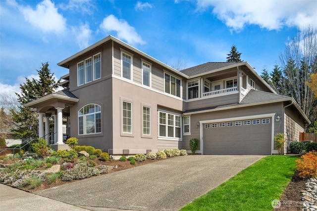prairie-style house featuring crawl space, stucco siding, a balcony, an attached garage, and concrete driveway