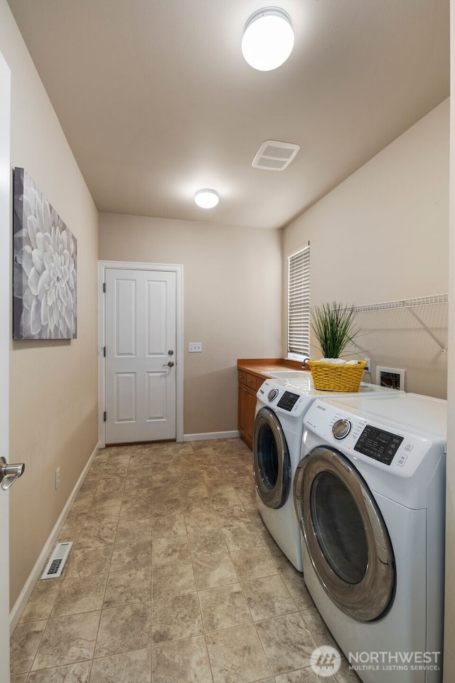 laundry area featuring cabinet space, visible vents, washing machine and clothes dryer, and baseboards