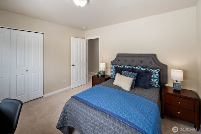 carpeted bedroom with a closet and baseboards