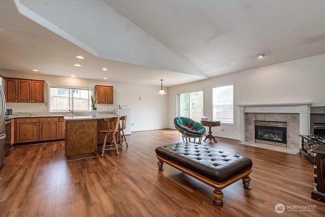 living area featuring recessed lighting, high vaulted ceiling, a fireplace, and dark wood finished floors