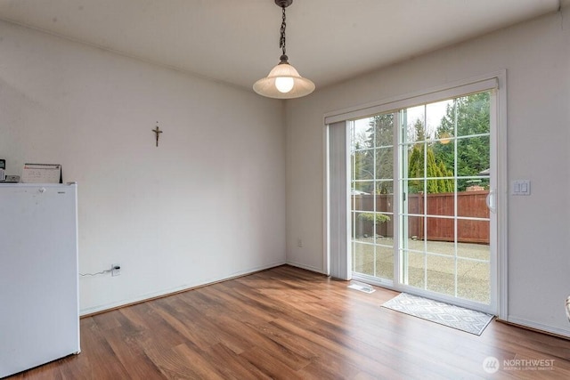 empty room featuring wood finished floors