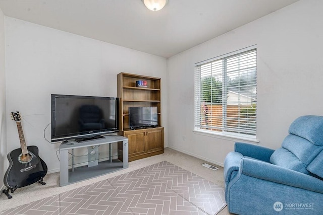 living area with baseboards, carpet floors, and visible vents