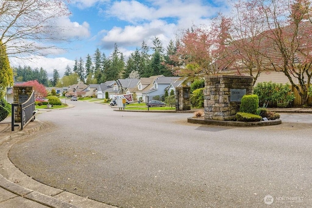 view of street with a residential view and curbs