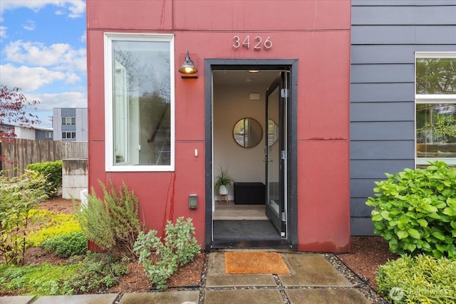 entrance to property featuring fence