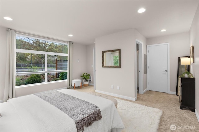 bedroom with light colored carpet, baseboards, and recessed lighting