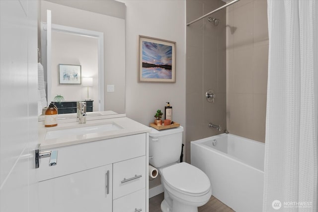 bathroom with toilet, wood finished floors, shower / bath combo with shower curtain, and vanity