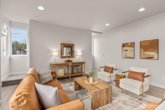 living room featuring recessed lighting, baseboards, and wood finished floors