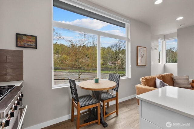 dining room with light wood-style flooring, baseboards, recessed lighting, and a wealth of natural light