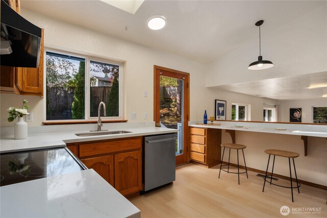 12204 30th St NE, Lake Stevens, WA 98258 - kitchen with brown cabinets, light wood-style floors, dishwasher, and a sink