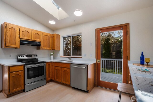 12204 30th St NE, Lake Stevens, WA 98258 - kitchen with under cabinet range hood, stainless steel appliances, light countertops, and a sink